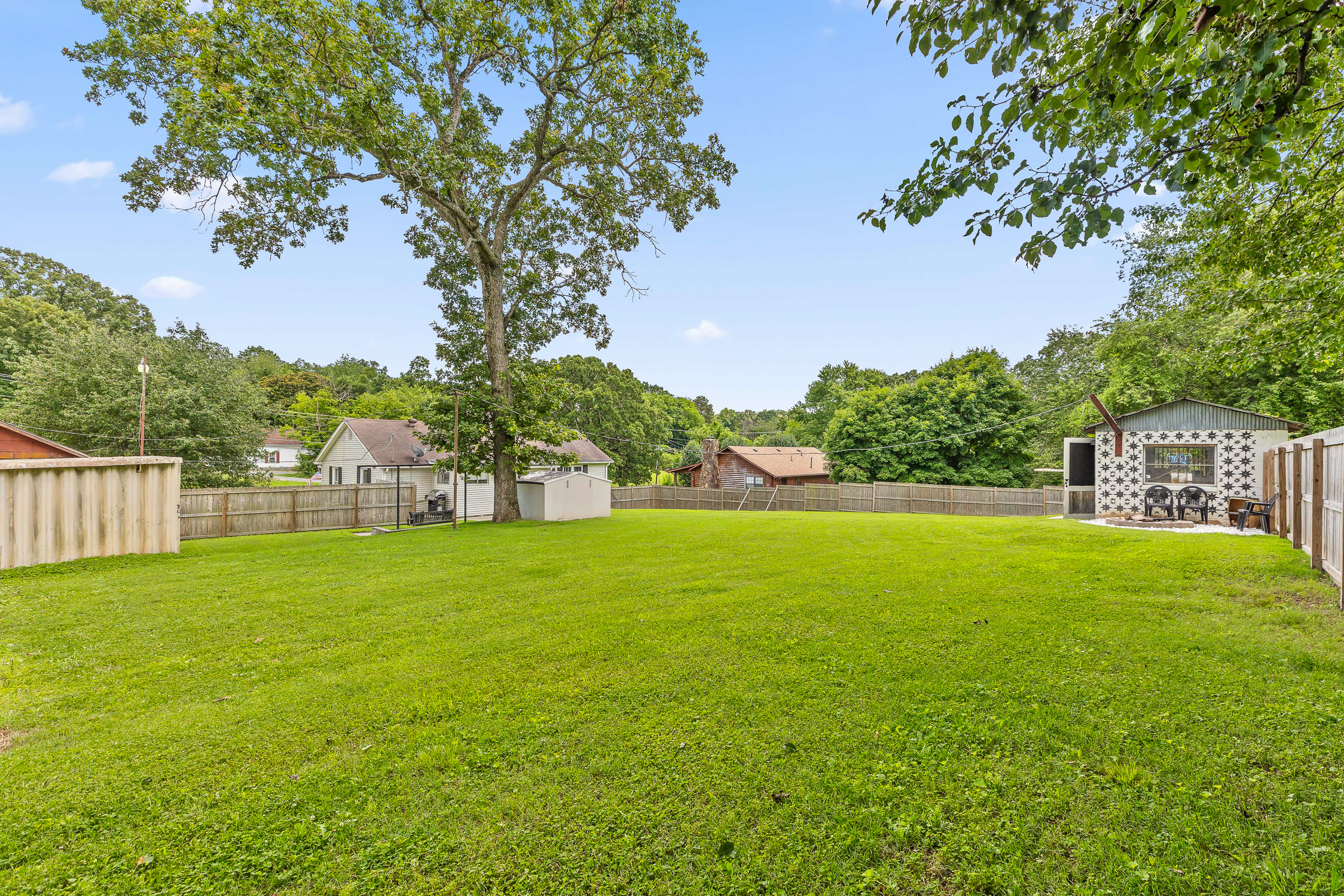 Large backyard with mature trees
